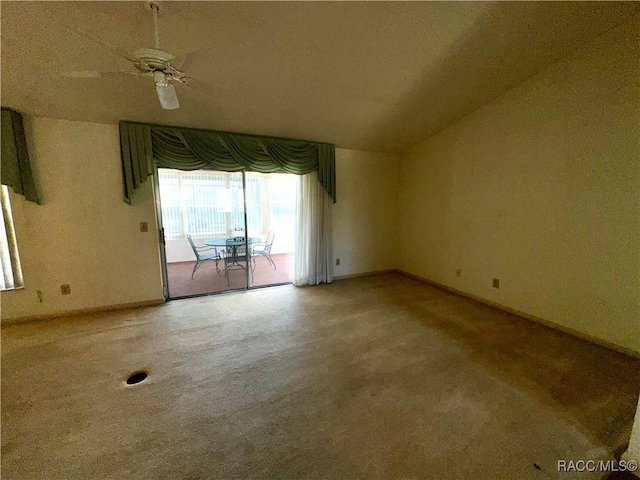 empty room with baseboards, lofted ceiling, and ceiling fan