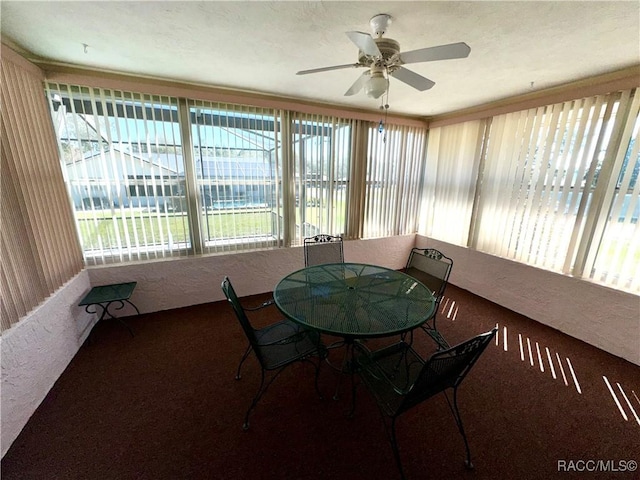 sunroom featuring ceiling fan