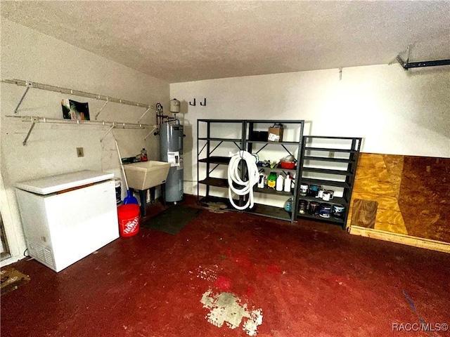 garage with refrigerator, water heater, and a sink