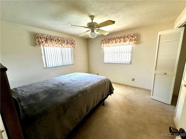 carpeted bedroom with a ceiling fan