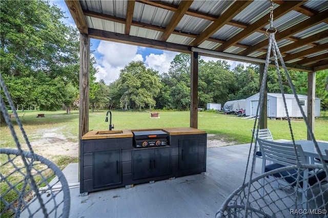 view of patio / terrace with an outdoor kitchen and sink