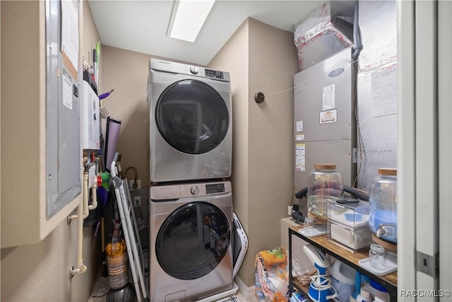 clothes washing area with stacked washer and clothes dryer