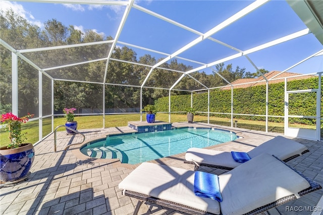 view of pool featuring pool water feature, glass enclosure, a yard, and a patio