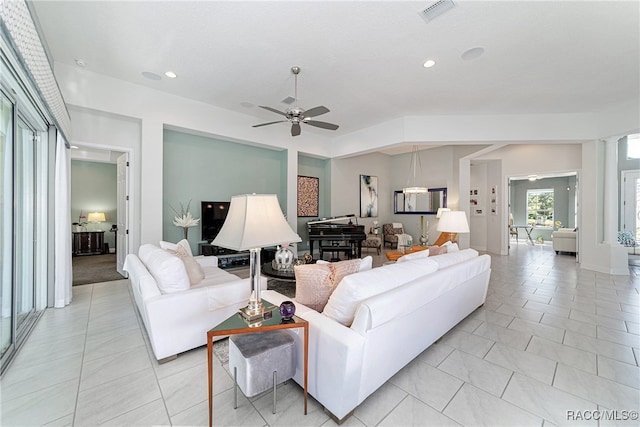 living room with ceiling fan and light tile patterned floors