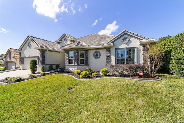 view of front of house featuring a front lawn and a garage