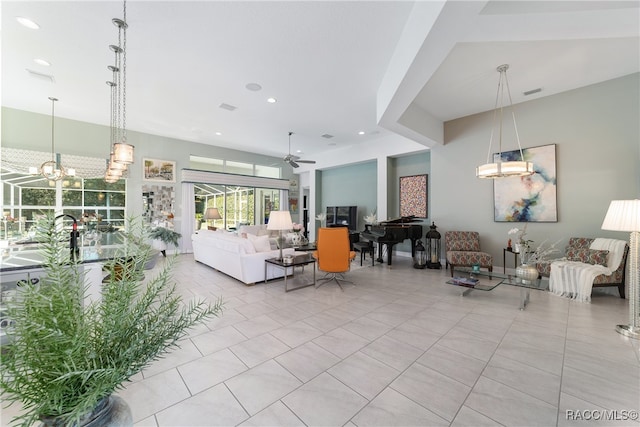 living room with ceiling fan with notable chandelier and light tile patterned flooring