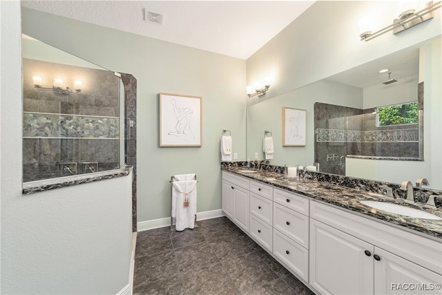 bathroom featuring vanity and tiled shower