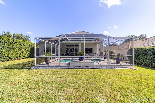 rear view of house featuring a fenced in pool, glass enclosure, a patio area, and a yard