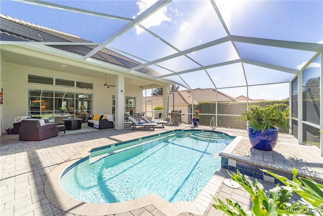 view of swimming pool with a patio area, ceiling fan, glass enclosure, and an outdoor hangout area