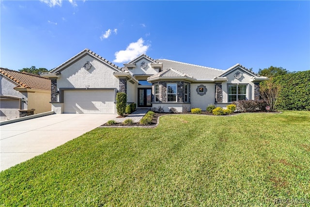 view of front of house featuring a front lawn and a garage