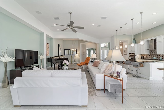 tiled living room with ceiling fan