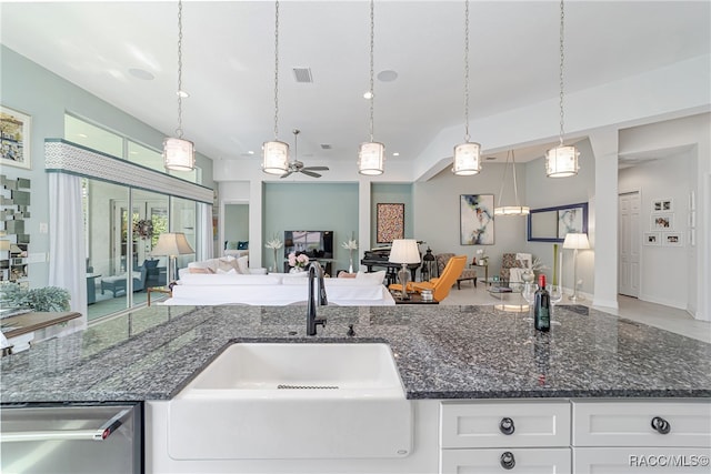 kitchen featuring white cabinets, ceiling fan, sink, and decorative light fixtures