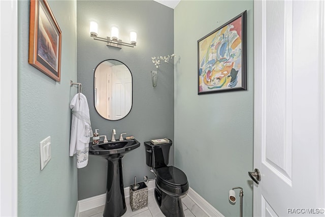 bathroom featuring tile patterned flooring and sink