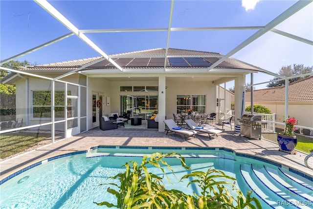 view of pool featuring a grill, a patio area, and an outdoor hangout area