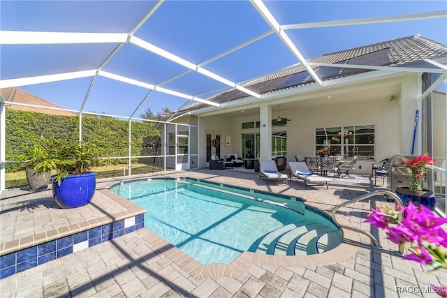 view of pool with a lanai, ceiling fan, and a patio area