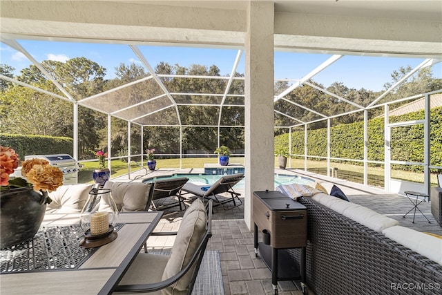 view of patio / terrace with an outdoor living space and glass enclosure