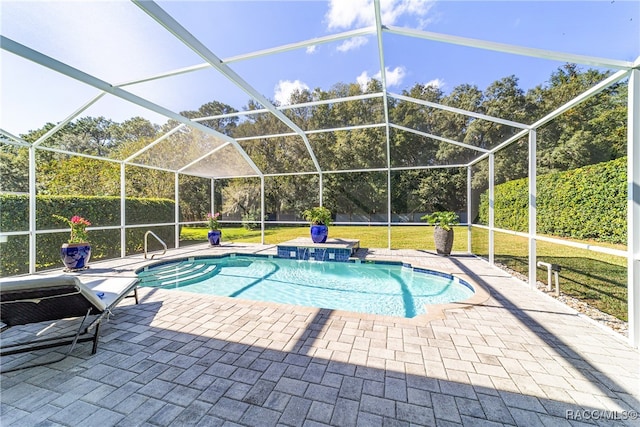 view of swimming pool featuring pool water feature, glass enclosure, a patio area, and a lawn