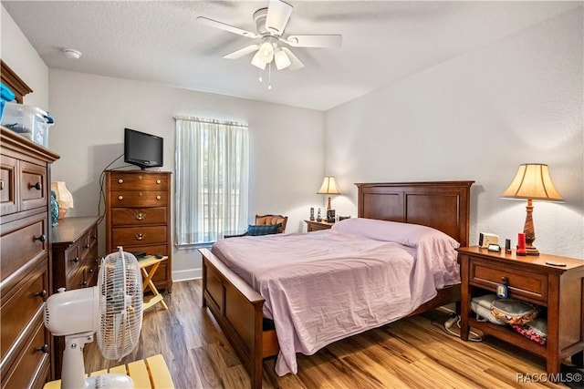 bedroom with a ceiling fan and wood finished floors