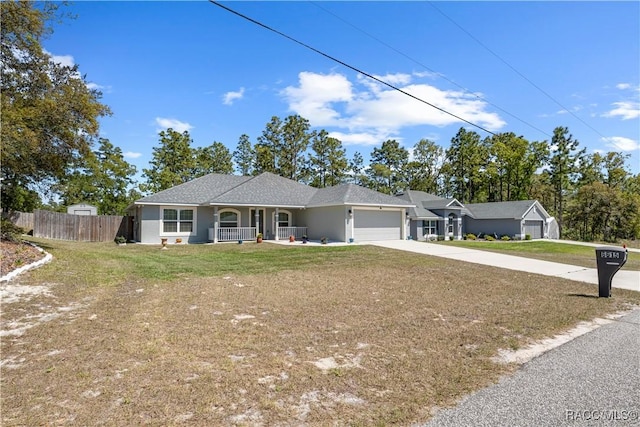 ranch-style house with driveway, covered porch, an attached garage, fence, and a front yard
