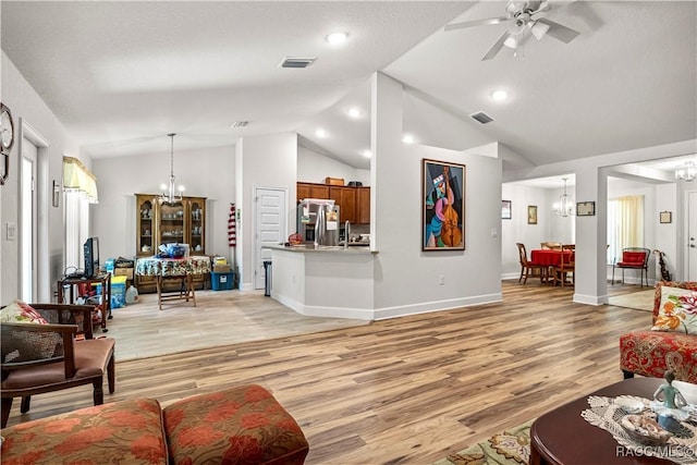 living area with baseboards, ceiling fan with notable chandelier, visible vents, and light wood-style flooring