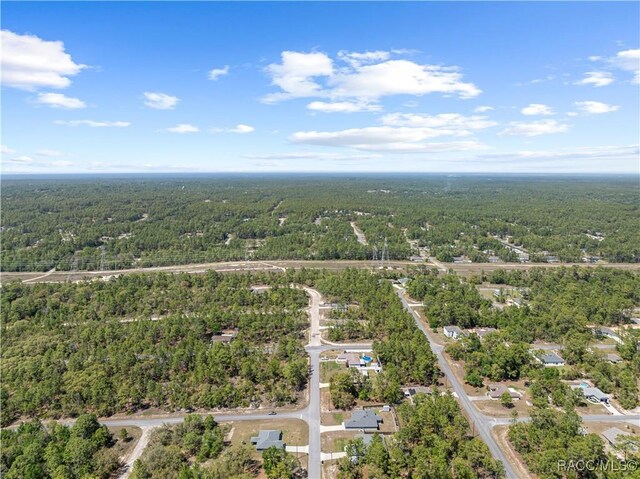 drone / aerial view featuring a view of trees