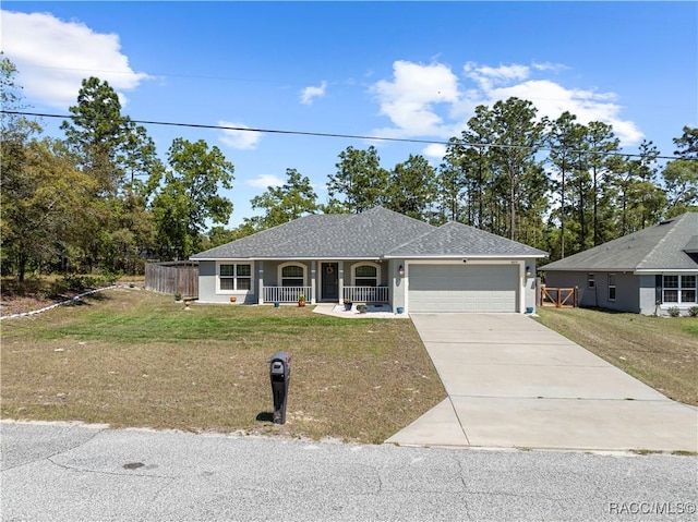 single story home featuring a porch, an attached garage, a front lawn, and concrete driveway
