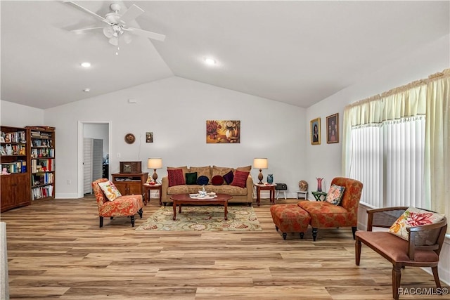 living area with light wood-type flooring, vaulted ceiling, recessed lighting, and a ceiling fan