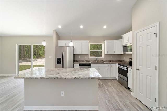 kitchen featuring light wood finished floors, white cabinetry, appliances with stainless steel finishes, and a sink