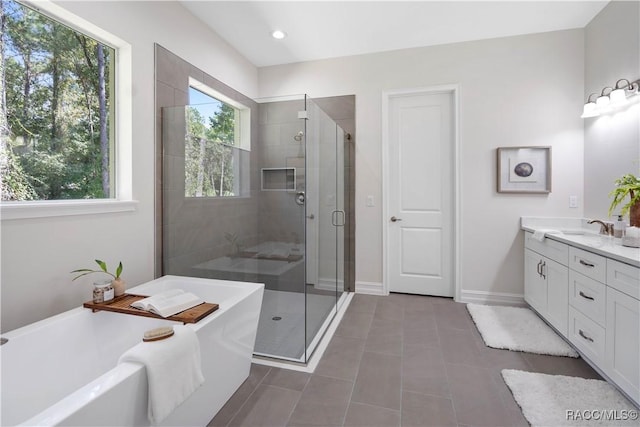 bathroom with tile patterned flooring, vanity, and separate shower and tub