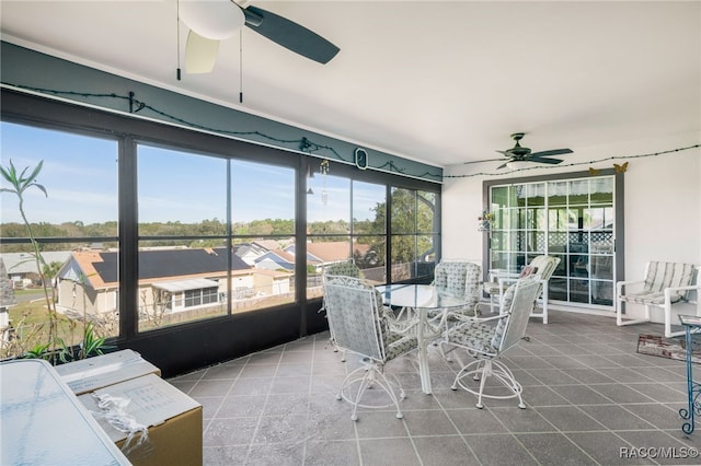 sunroom / solarium featuring a ceiling fan