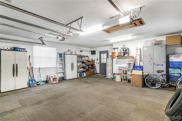 garage featuring visible vents, electric water heater, and a garage door opener