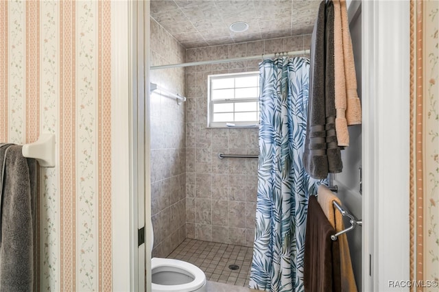 full bathroom featuring a shower stall and toilet