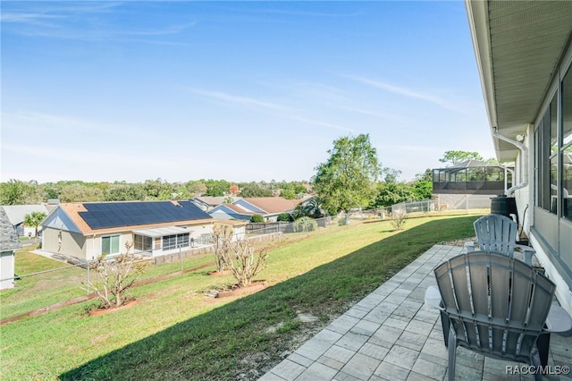 view of yard with a patio, a fenced backyard, and a residential view