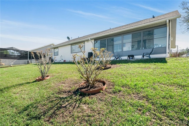 rear view of house with a lawn