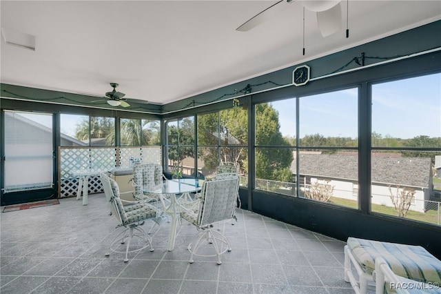 sunroom / solarium featuring ceiling fan