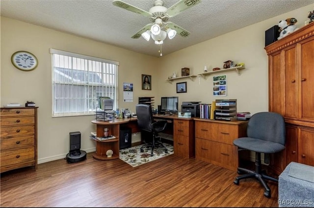 home office with a textured ceiling, light wood finished floors, a ceiling fan, and baseboards