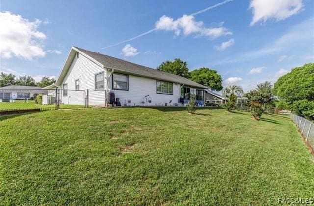 exterior space featuring a front lawn and fence