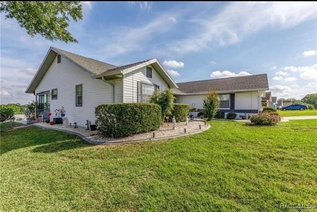 rear view of property with a lawn