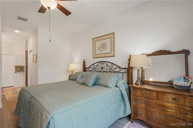 bedroom with wood-type flooring and ceiling fan