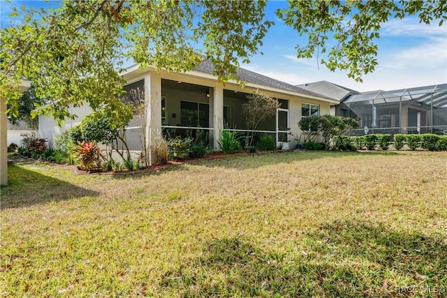 back of house with a lawn