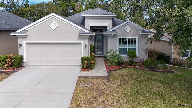 view of front of home featuring a garage and a front lawn