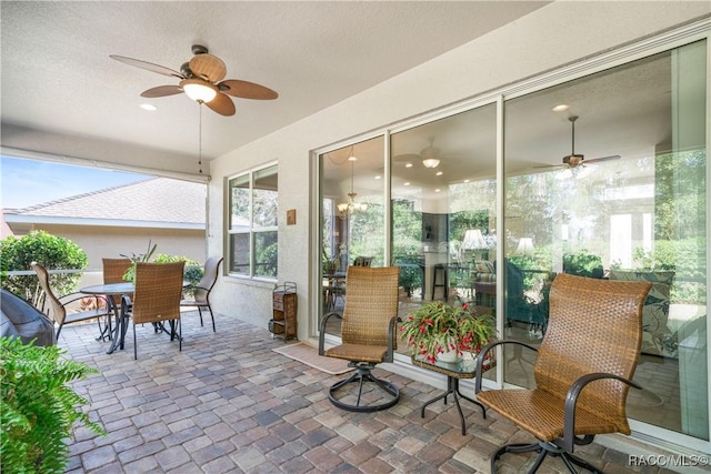 sunroom with plenty of natural light and ceiling fan