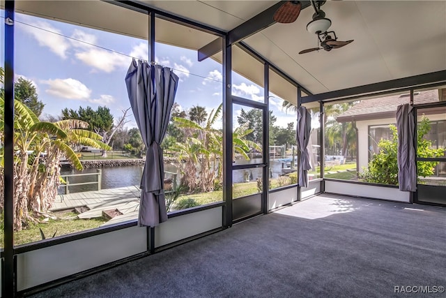 unfurnished sunroom with a water view, ceiling fan, and lofted ceiling