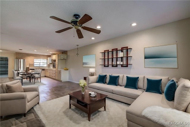 living room with ceiling fan and a wall unit AC