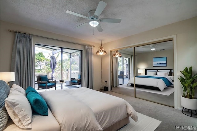 carpeted bedroom with ceiling fan, a textured ceiling, and a closet