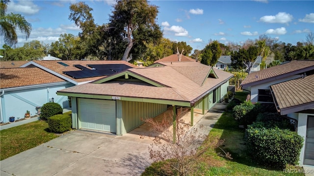 view of front of home with a garage and solar panels