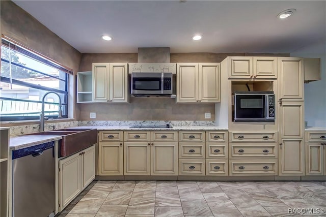 kitchen featuring black appliances, sink, and cream cabinets