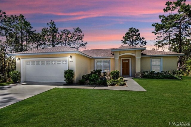 ranch-style house with a garage and a front yard