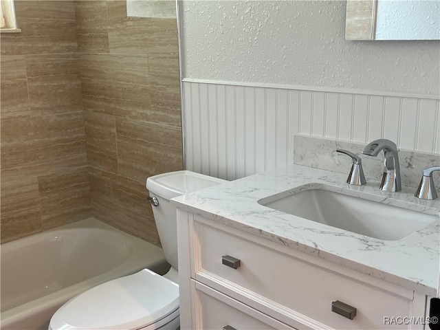 bathroom featuring vanity, toilet, and a bathtub