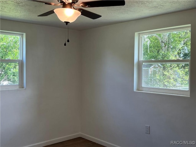 spare room with ceiling fan and dark hardwood / wood-style flooring